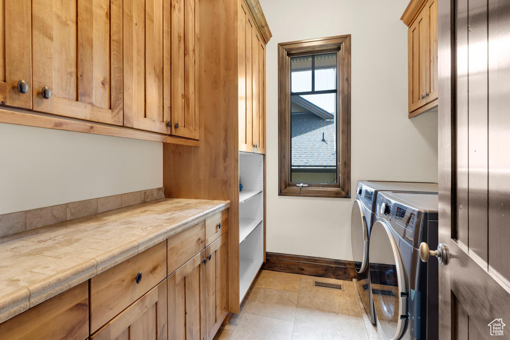 Washroom with cabinet space and independent washer and dryer