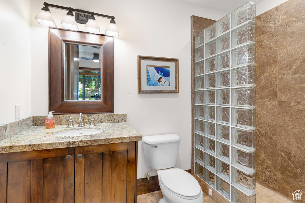 Bathroom featuring a walk in shower and vanity