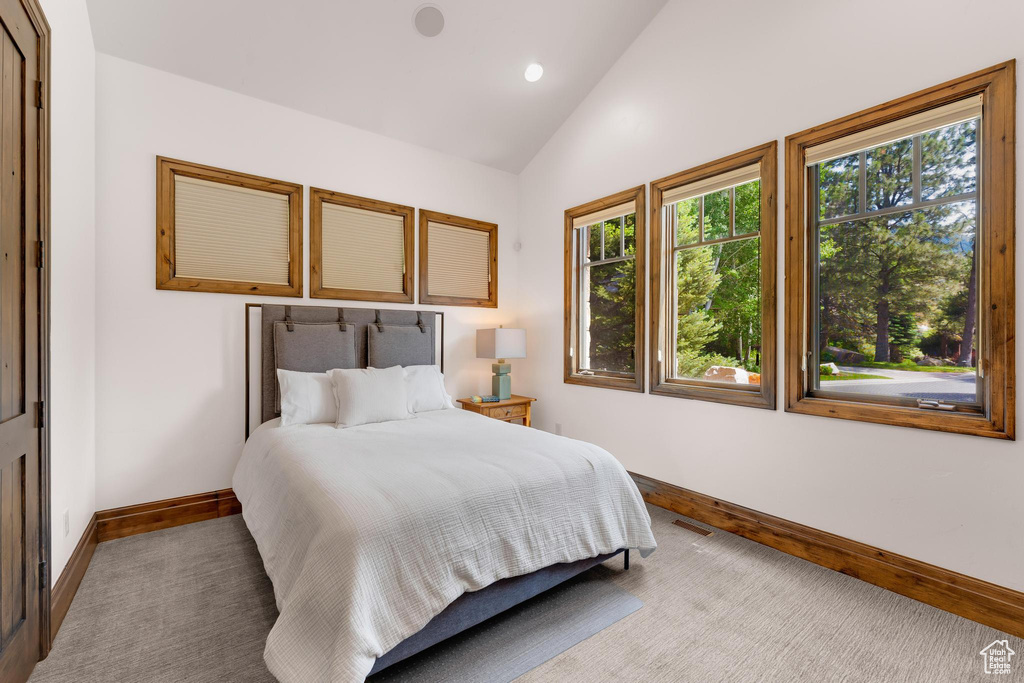 Bedroom with lofted ceiling and recessed lighting