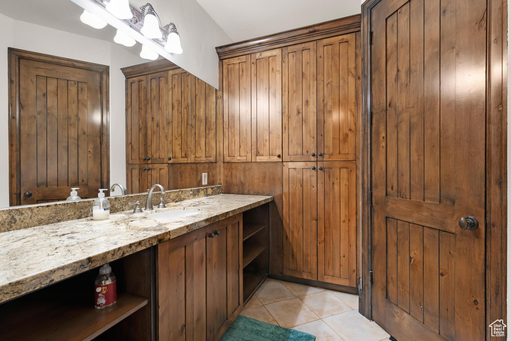 Bathroom with tile patterned floors and vanity