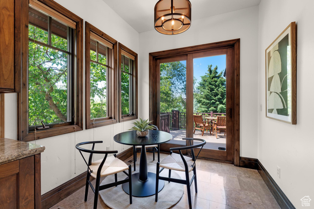 Dining area with baseboards and a chandelier