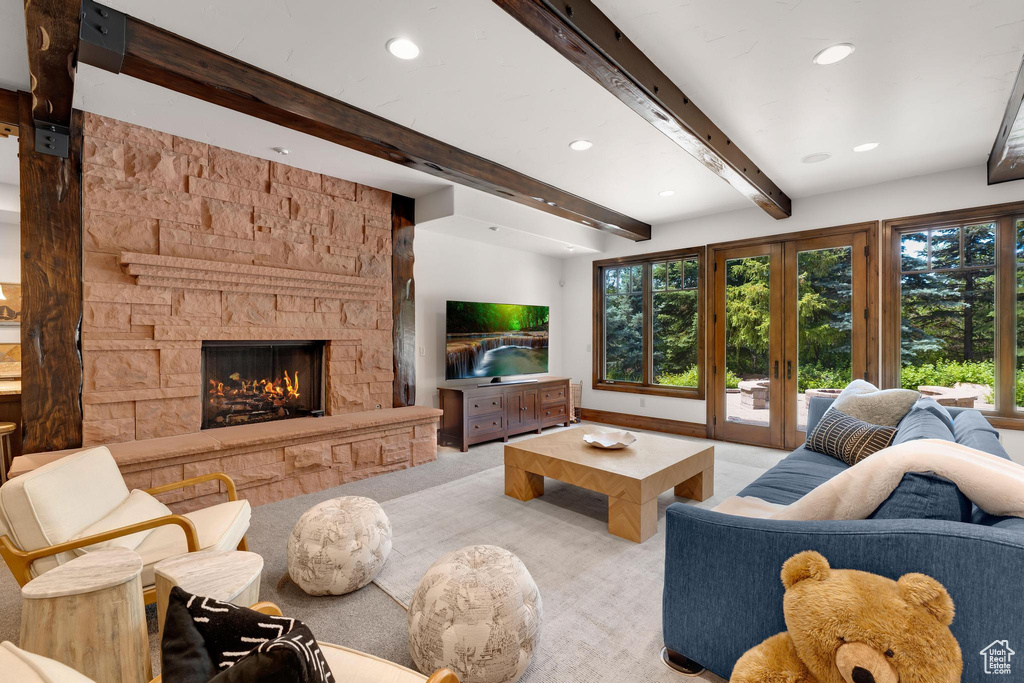 Carpeted living room featuring recessed lighting, a fireplace, and beam ceiling