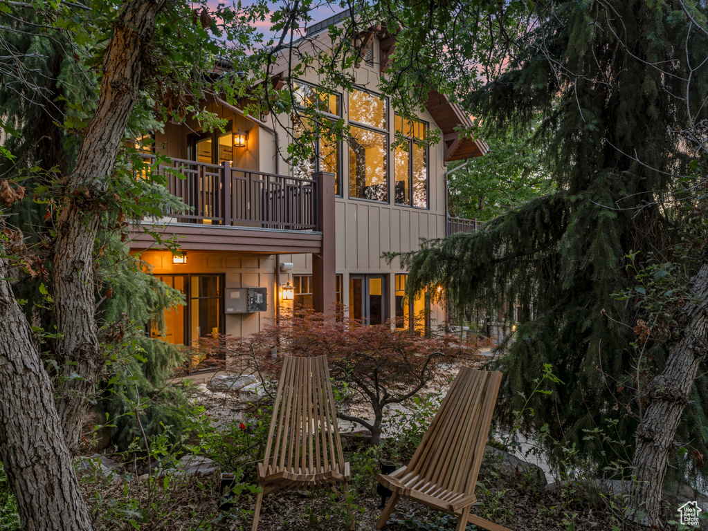 Back of property with a balcony and board and batten siding