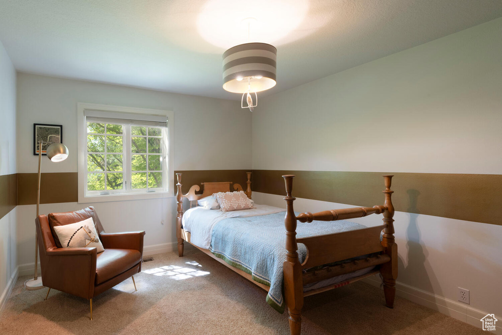 Bedroom featuring carpet and baseboards