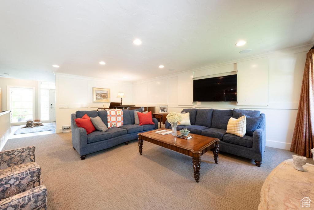 Living room featuring light colored carpet, recessed lighting, and ornamental molding