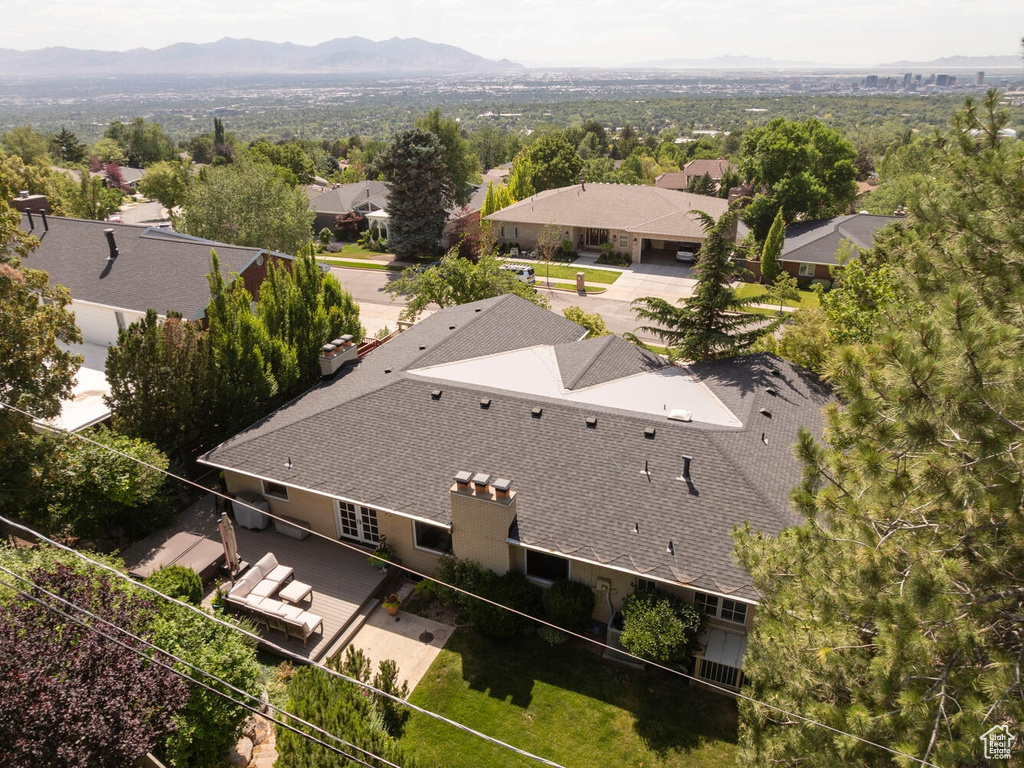 Aerial perspective of suburban area featuring a mountain backdrop and property parcel outlined