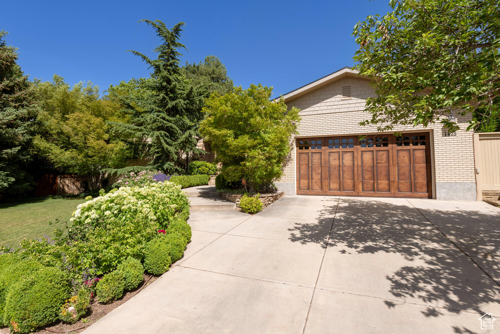 View of front of property with concrete driveway and brick siding