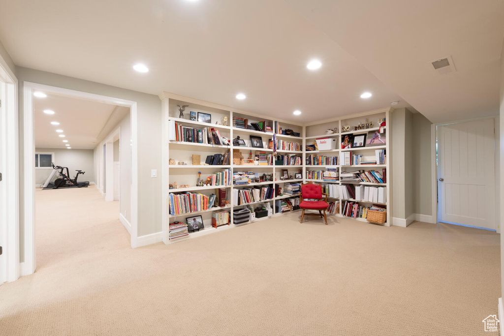 Living area with carpet floors and recessed lighting