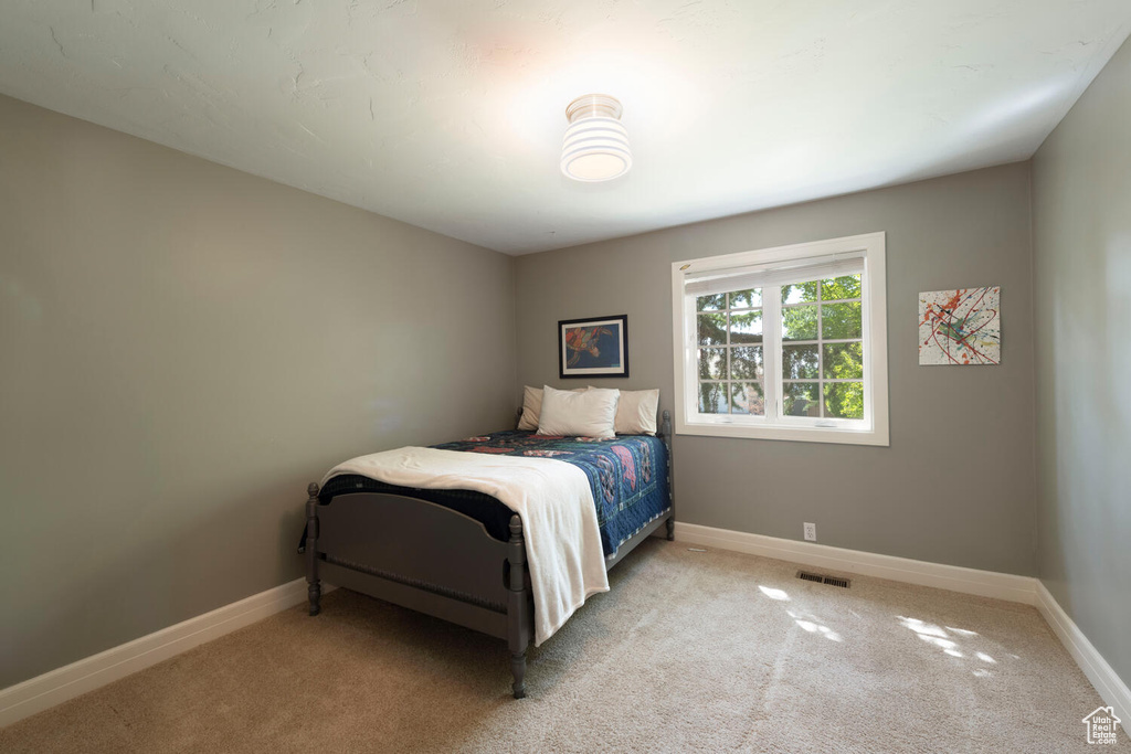 Bedroom with carpet flooring and baseboards
