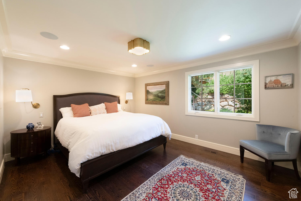 Bedroom with ornamental molding, wood finished floors, and recessed lighting