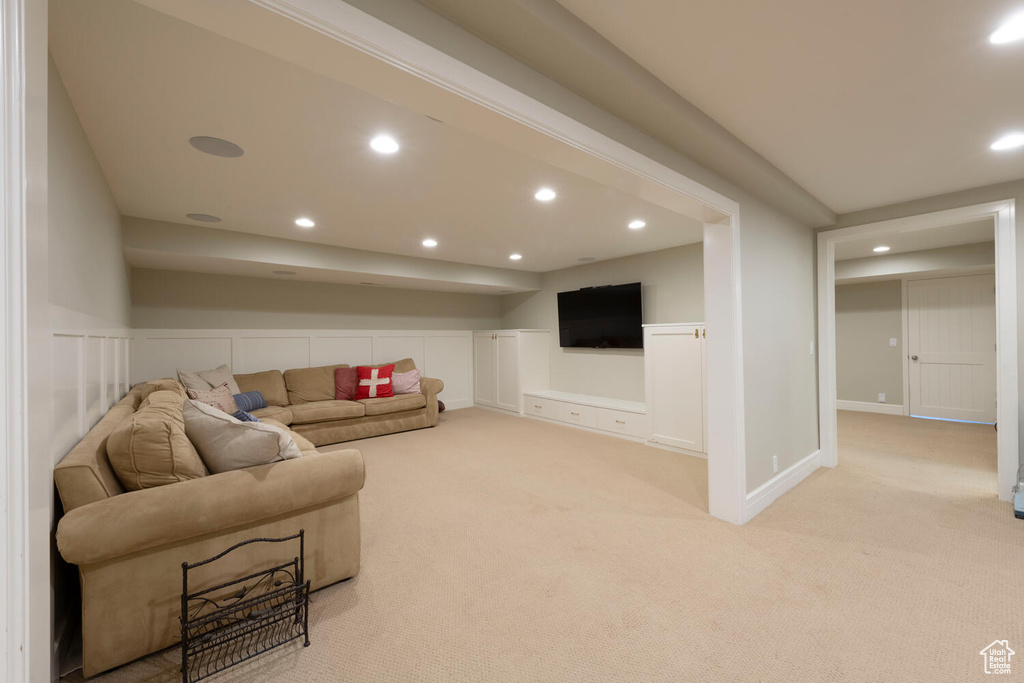 Carpeted living area featuring recessed lighting