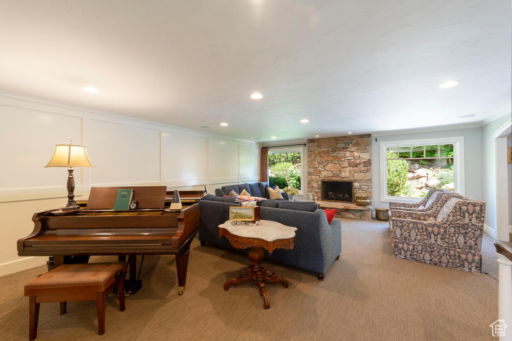 Carpeted living room with crown molding, a fireplace, and recessed lighting