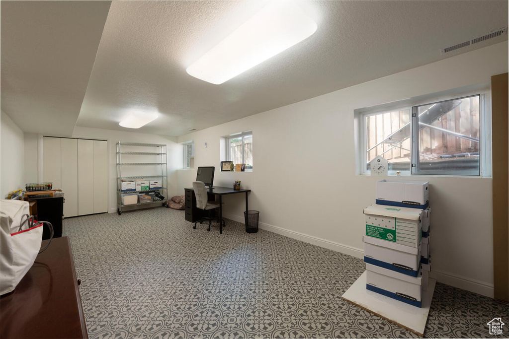 Office featuring baseboards and a textured ceiling