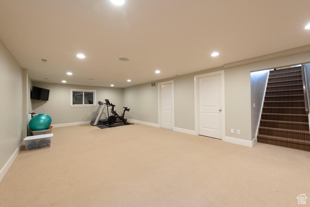 Workout room featuring recessed lighting and light carpet