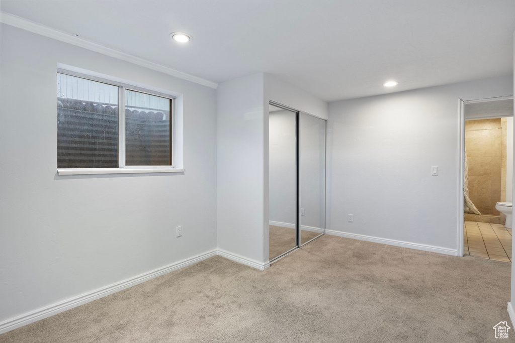 Unfurnished bedroom with carpet flooring, recessed lighting, a closet, and ornamental molding