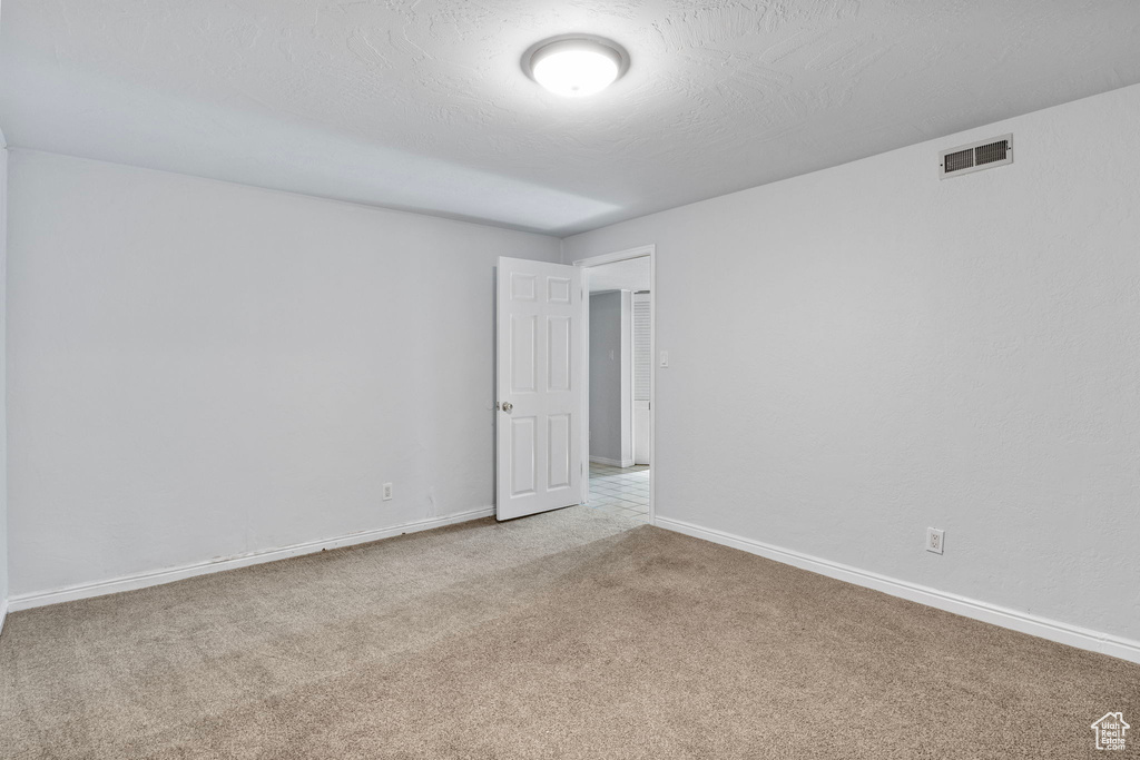 Unfurnished room featuring carpet floors and baseboards