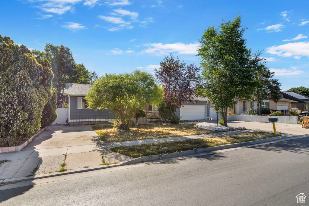 Obstructed view of property featuring driveway and a garage