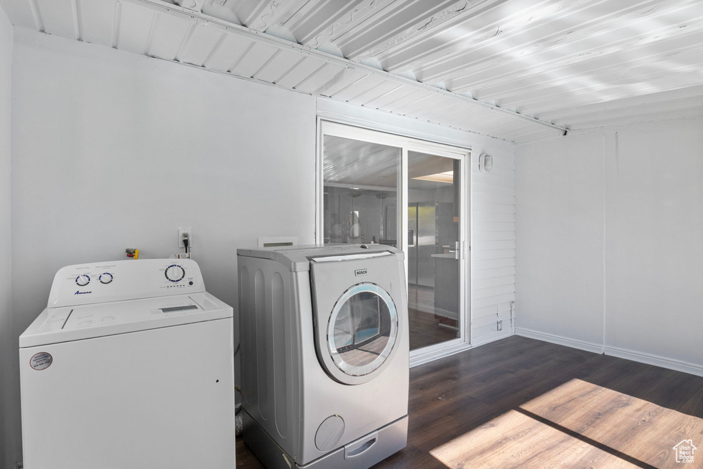 Laundry room with separate washer and dryer and dark wood-style flooring