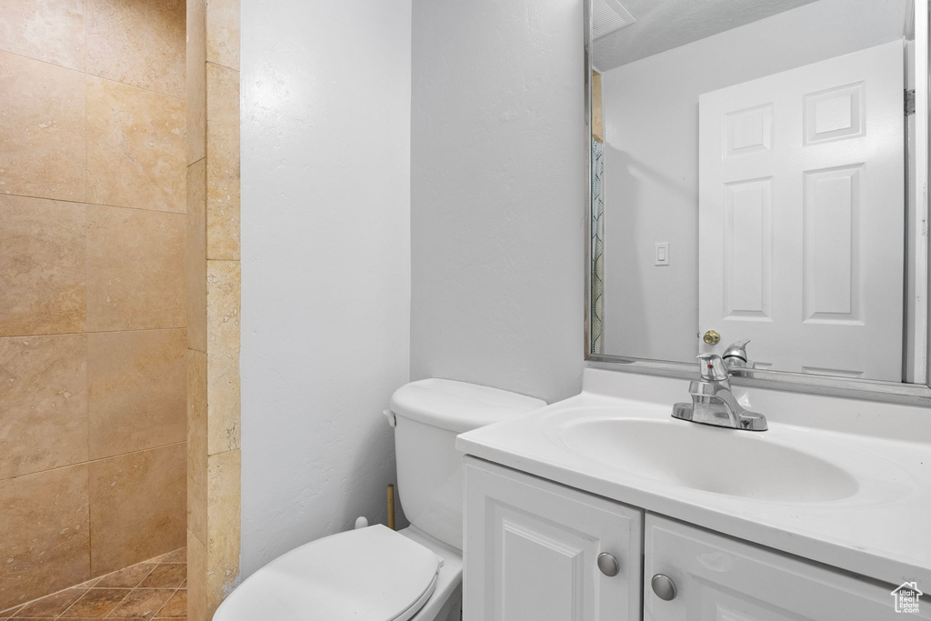 Bathroom featuring vanity and tiled shower