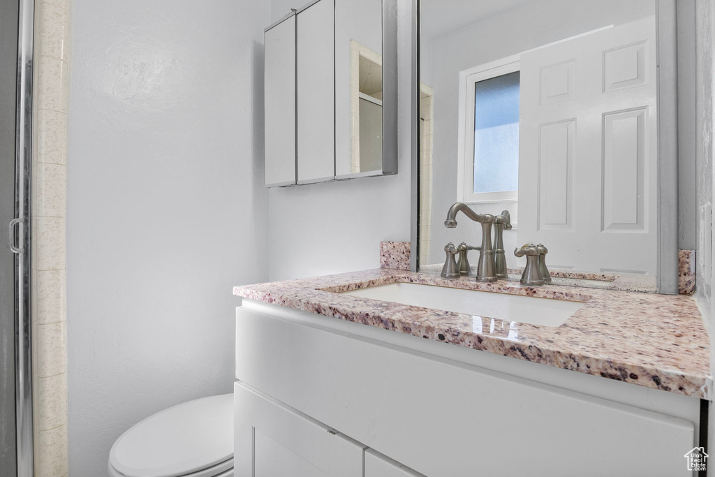 Bathroom featuring vanity and a stall shower