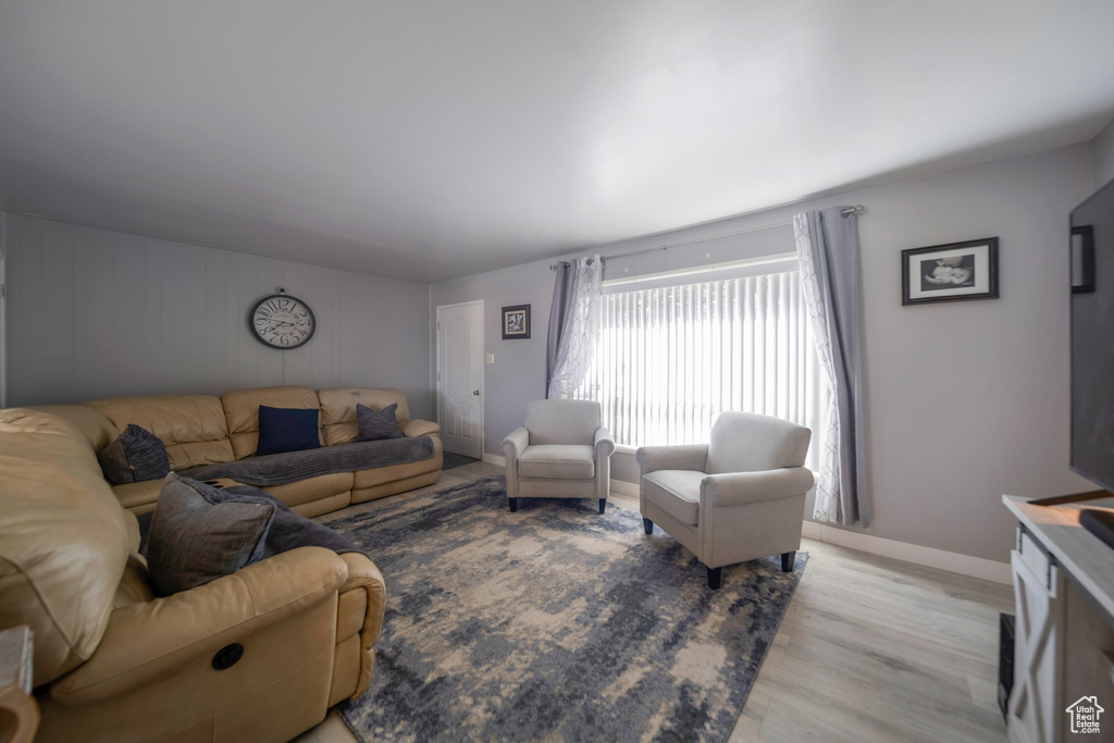 Living room with light wood-type flooring and baseboards