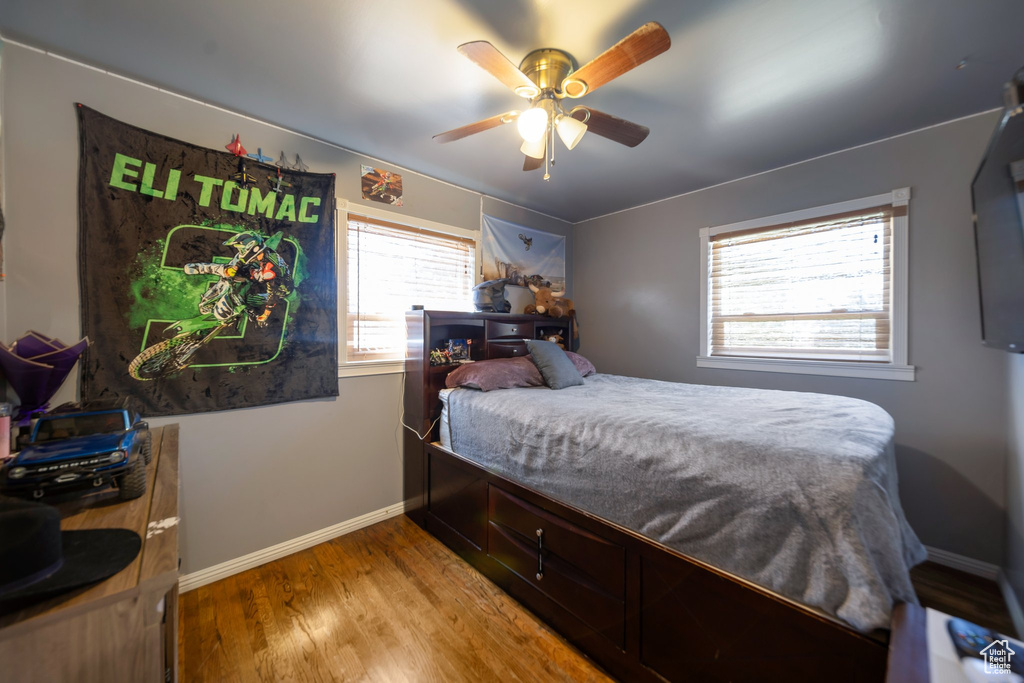 Bedroom with wood finished floors and a ceiling fan