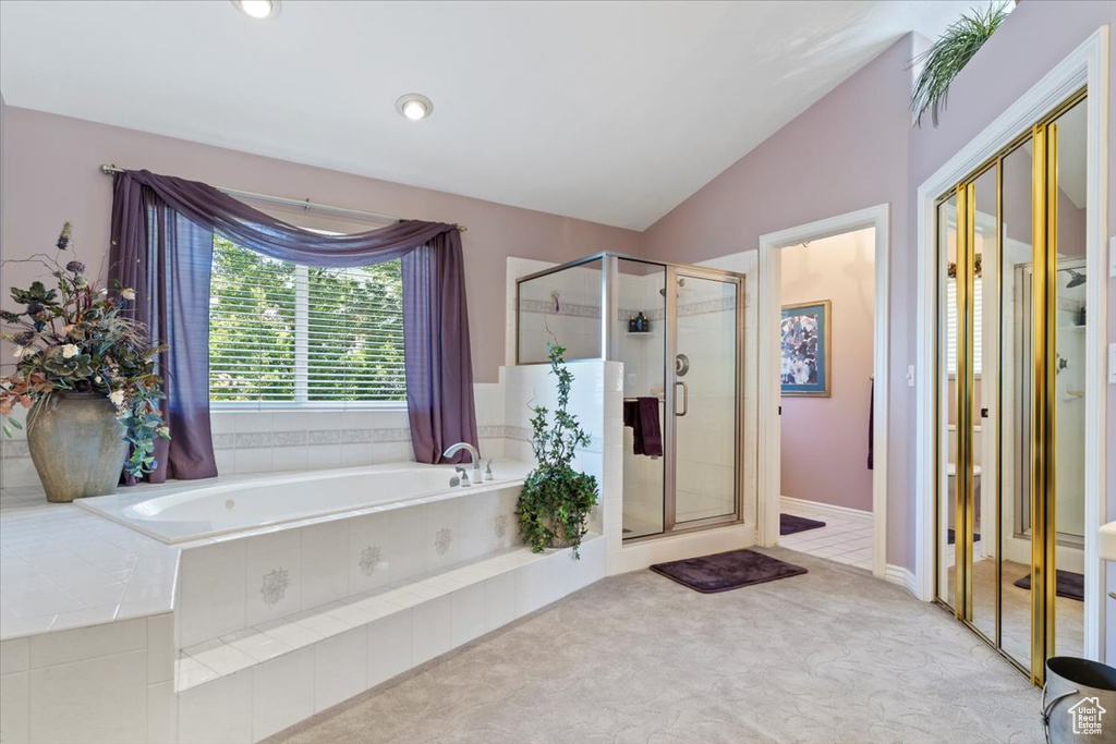 Full bathroom featuring a bath, a shower stall, vaulted ceiling, and recessed lighting