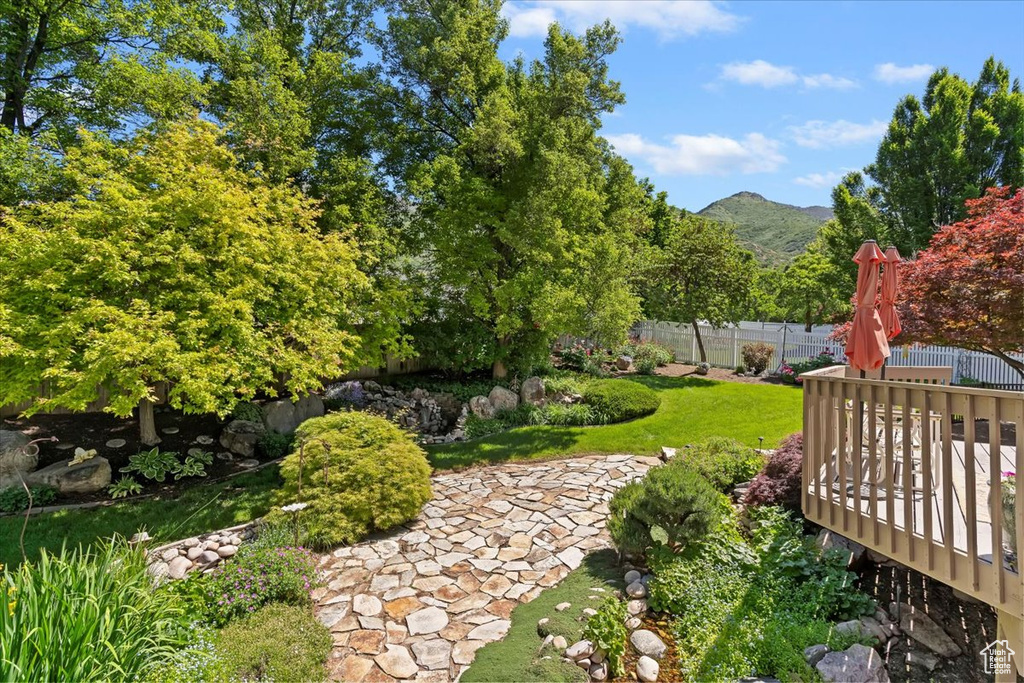 View of yard featuring a deck with mountain view
