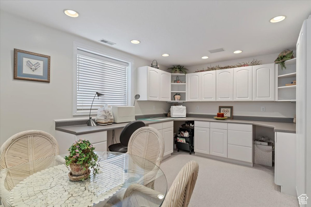 Office area featuring built in desk, recessed lighting, and light carpet