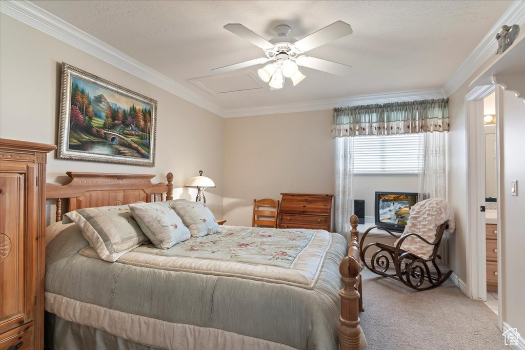Carpeted bedroom featuring ornamental molding and ceiling fan