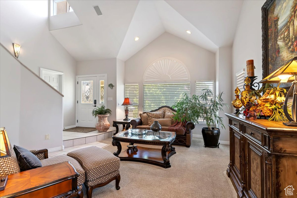 Living room featuring vaulted ceiling, light colored carpet, and recessed lighting