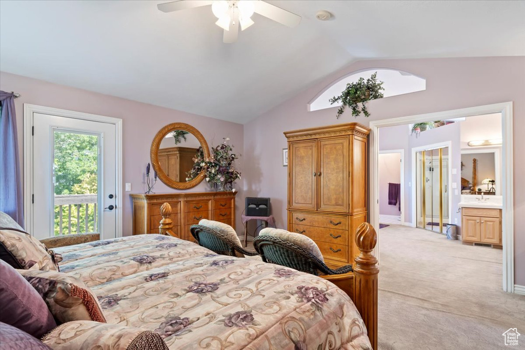 Bedroom with access to exterior, light colored carpet, vaulted ceiling, and a ceiling fan