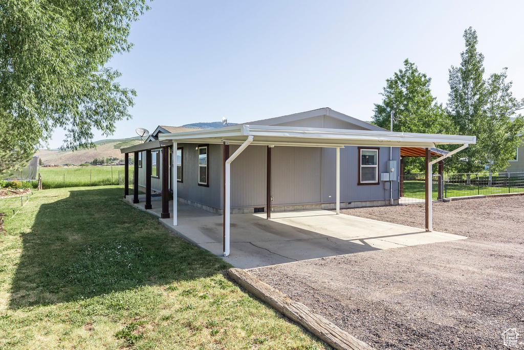 View of home's exterior with an attached carport and crawl space