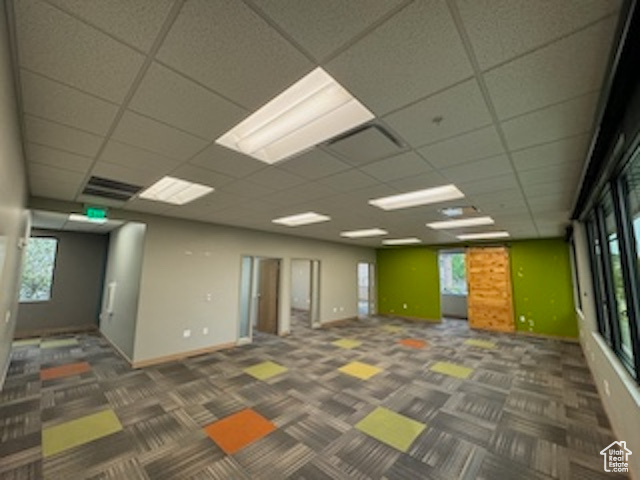 Carpeted spare room with a paneled ceiling