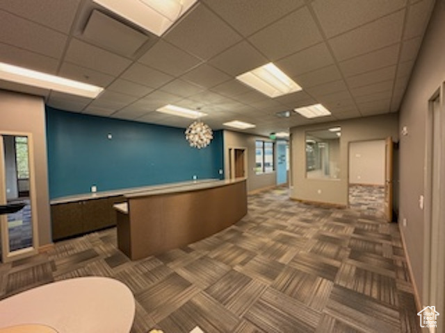 Reception area with a drop ceiling and a chandelier