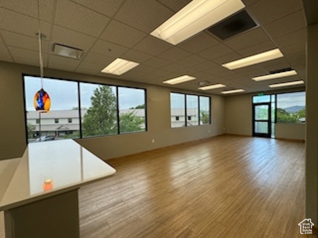 Empty room featuring a drop ceiling and wood finished floors