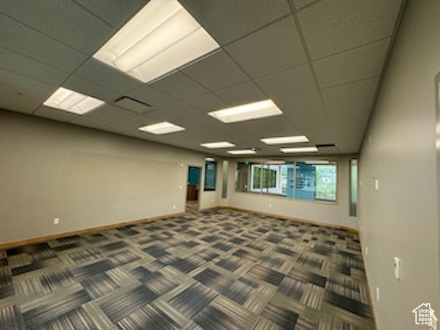 Carpeted spare room with baseboards