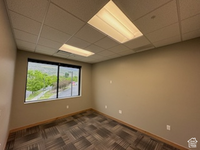 Empty room with a paneled ceiling