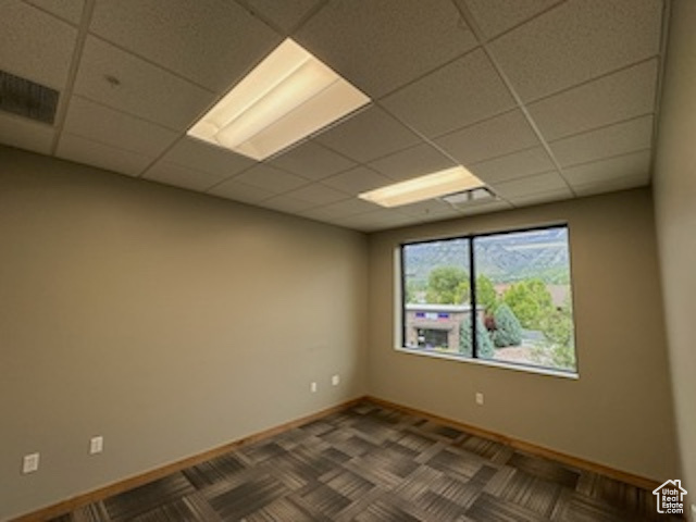 Unfurnished room with a paneled ceiling