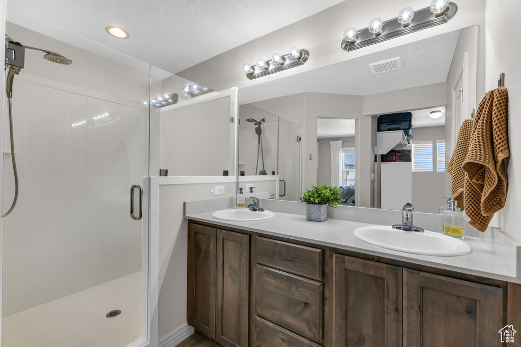 Bathroom with a stall shower and double vanity