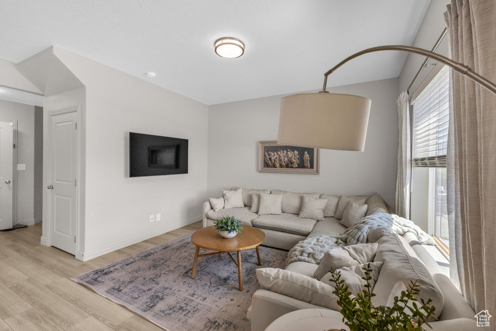 Living area with light wood-type flooring and baseboards
