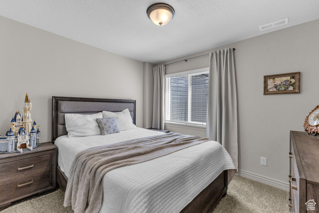 Bedroom featuring carpet flooring and baseboards