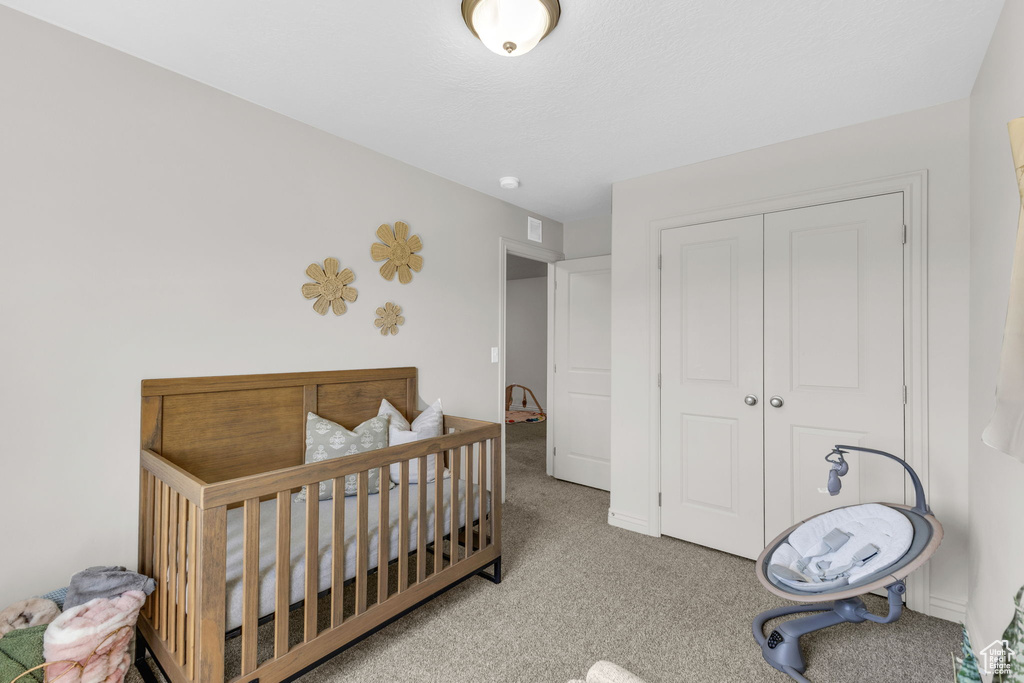 Bedroom featuring carpet floors and a closet