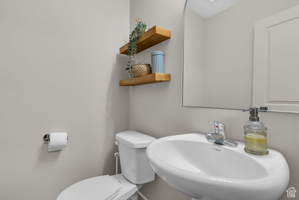 Half bath with toilet and a sink