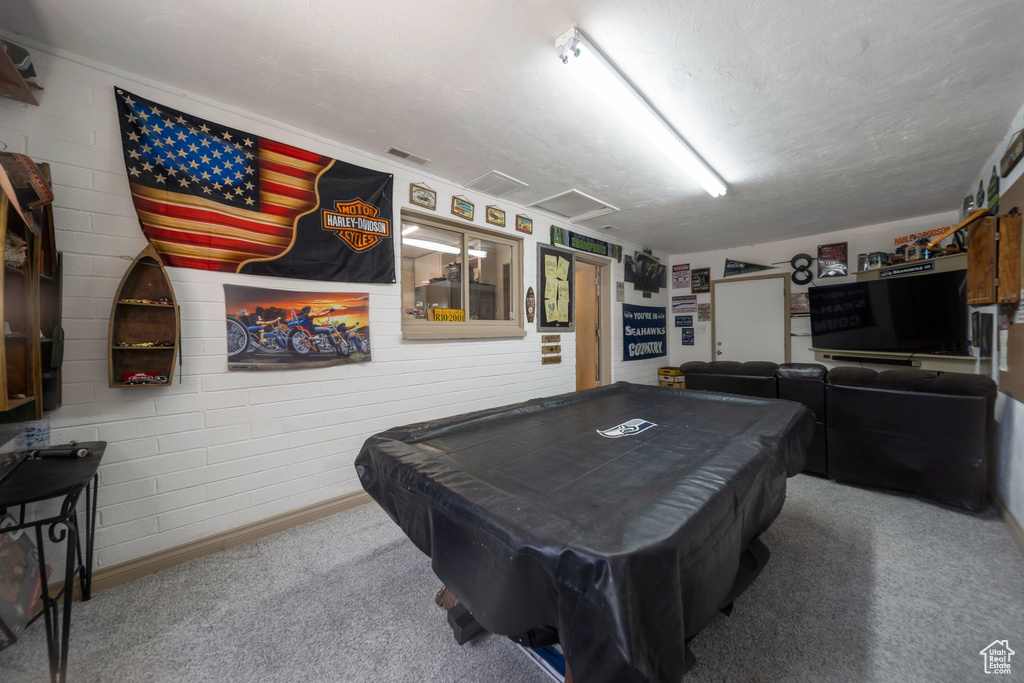 Recreation room featuring carpet flooring, pool table, and a textured ceiling