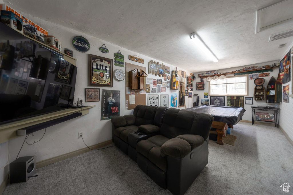 Living room featuring billiards table, carpet flooring, and a textured ceiling