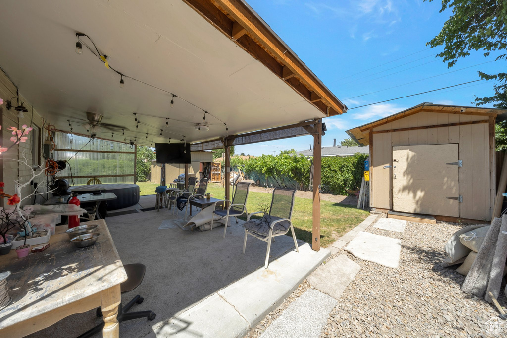 View of patio with a shed