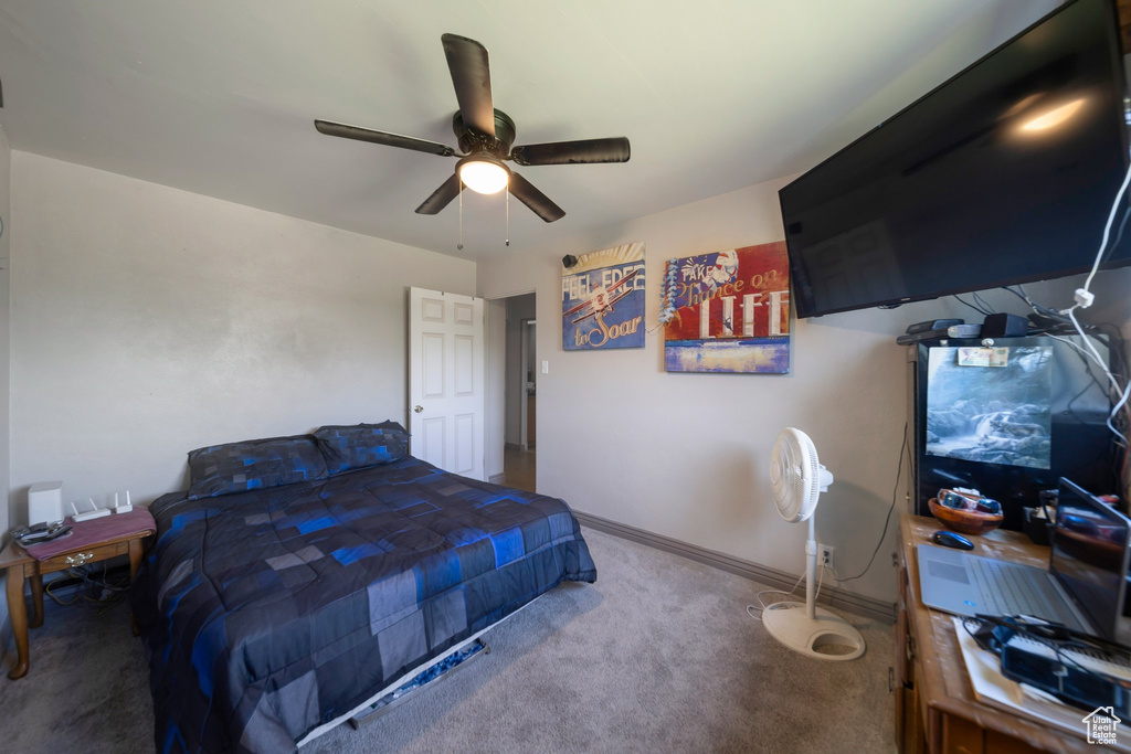 Bedroom with carpet floors and a ceiling fan