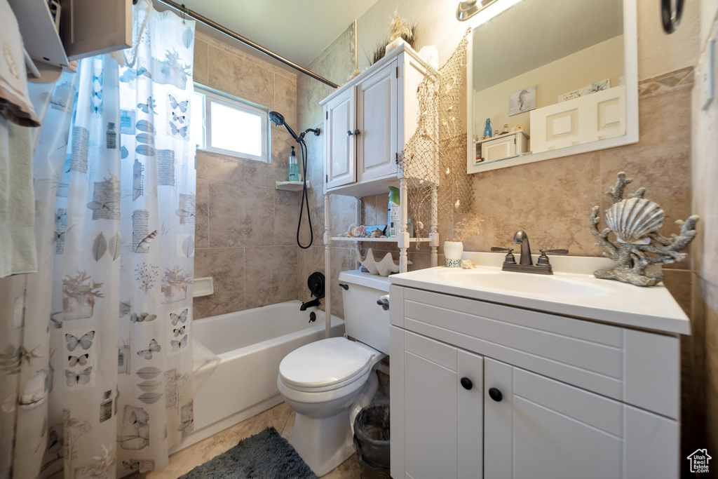 Full bathroom featuring shower / bathtub combination with curtain and vanity