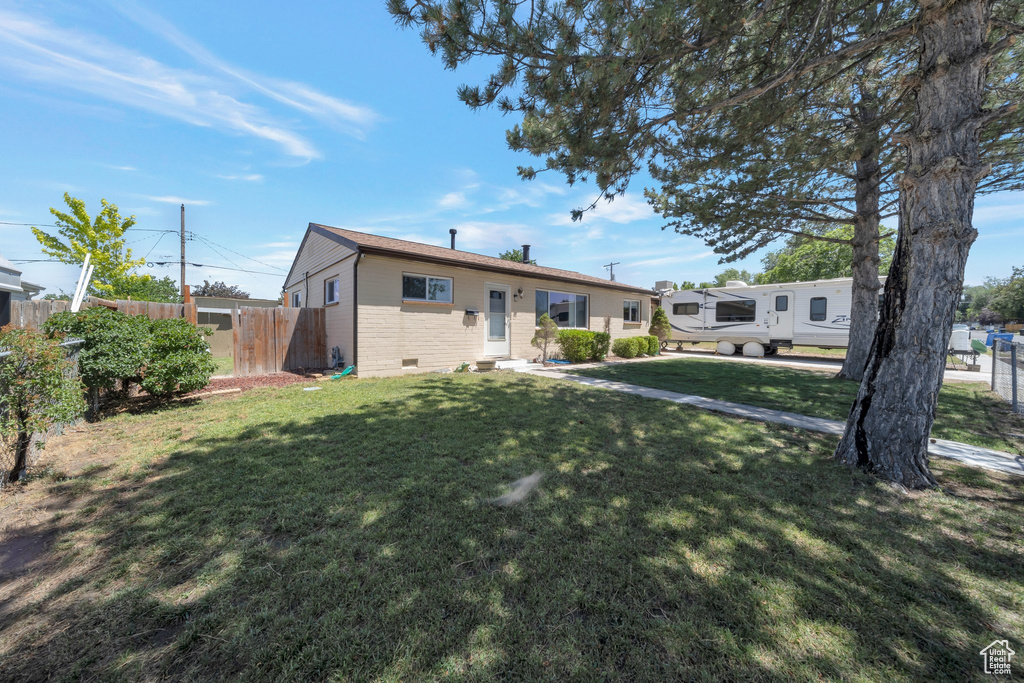 View of front of property with brick siding and crawl space